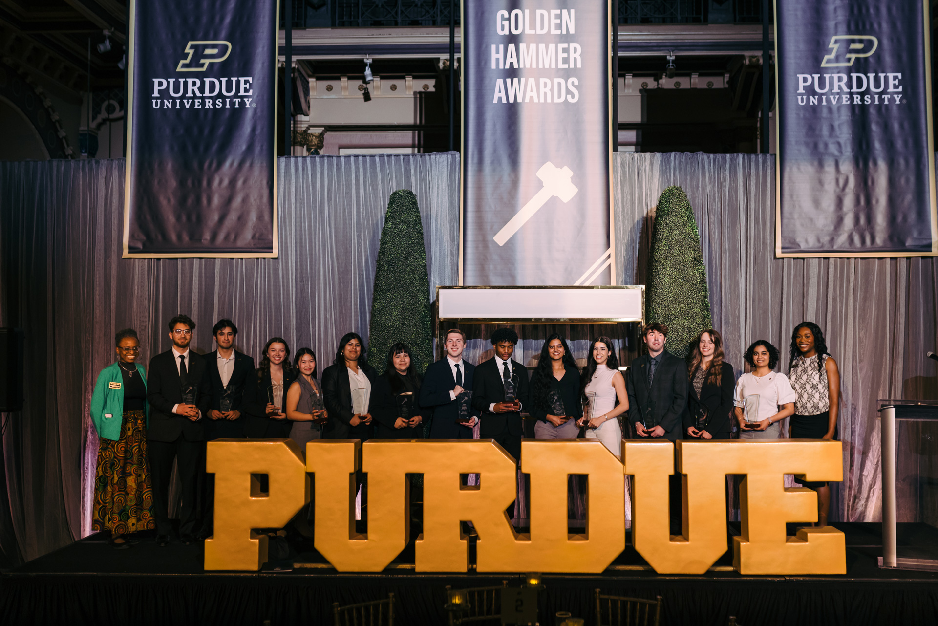 A group of winners on stage during the Golden Hammer Awards event. 